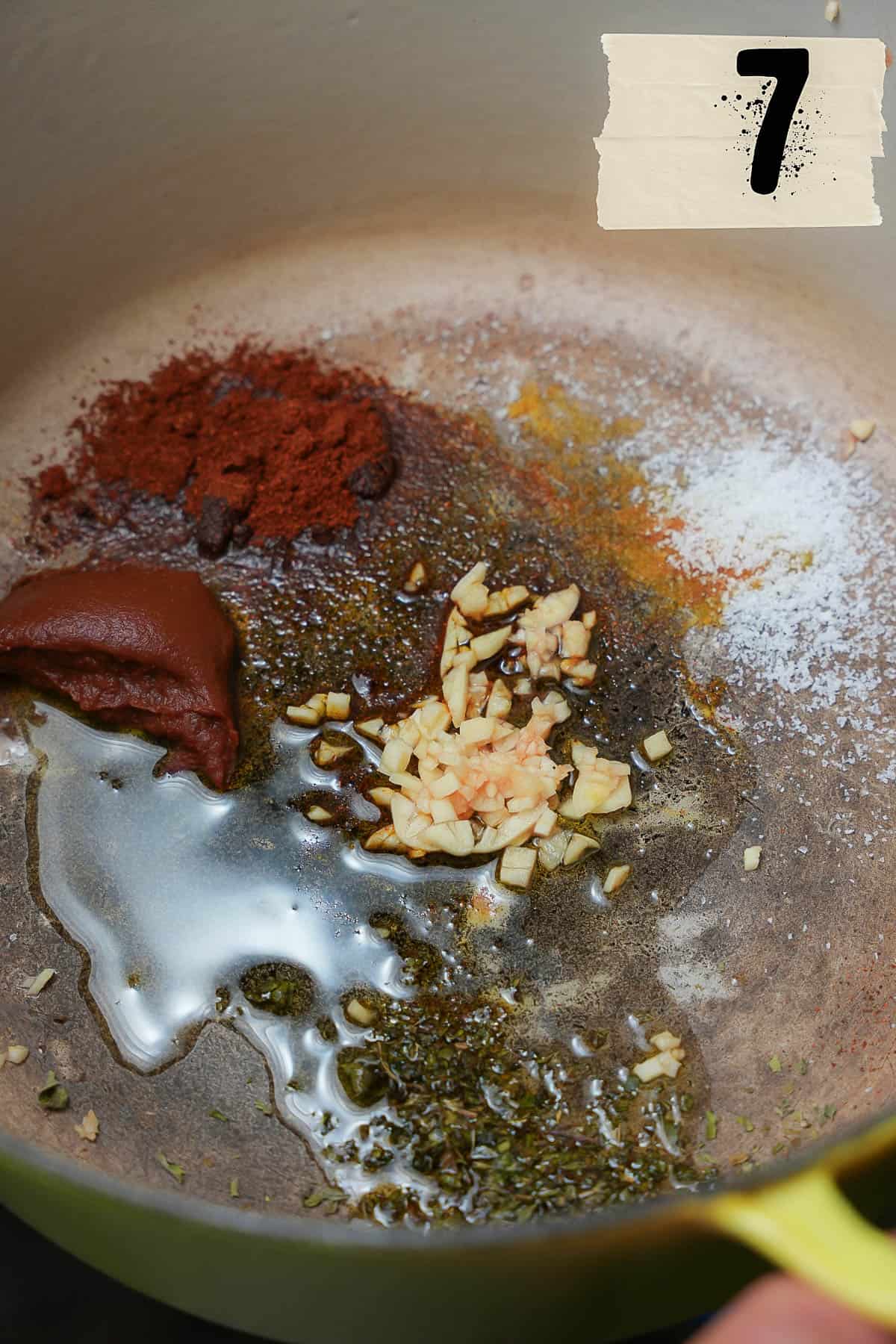 The base for the cooking liquid is mixed together in the bottom of a yellow pot.