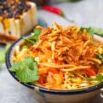 A bowl of asinan sayur with tofu and chili crisp.