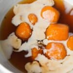 A bowl with a bowl of biji salak, the syrup blending with to coconut sauce.