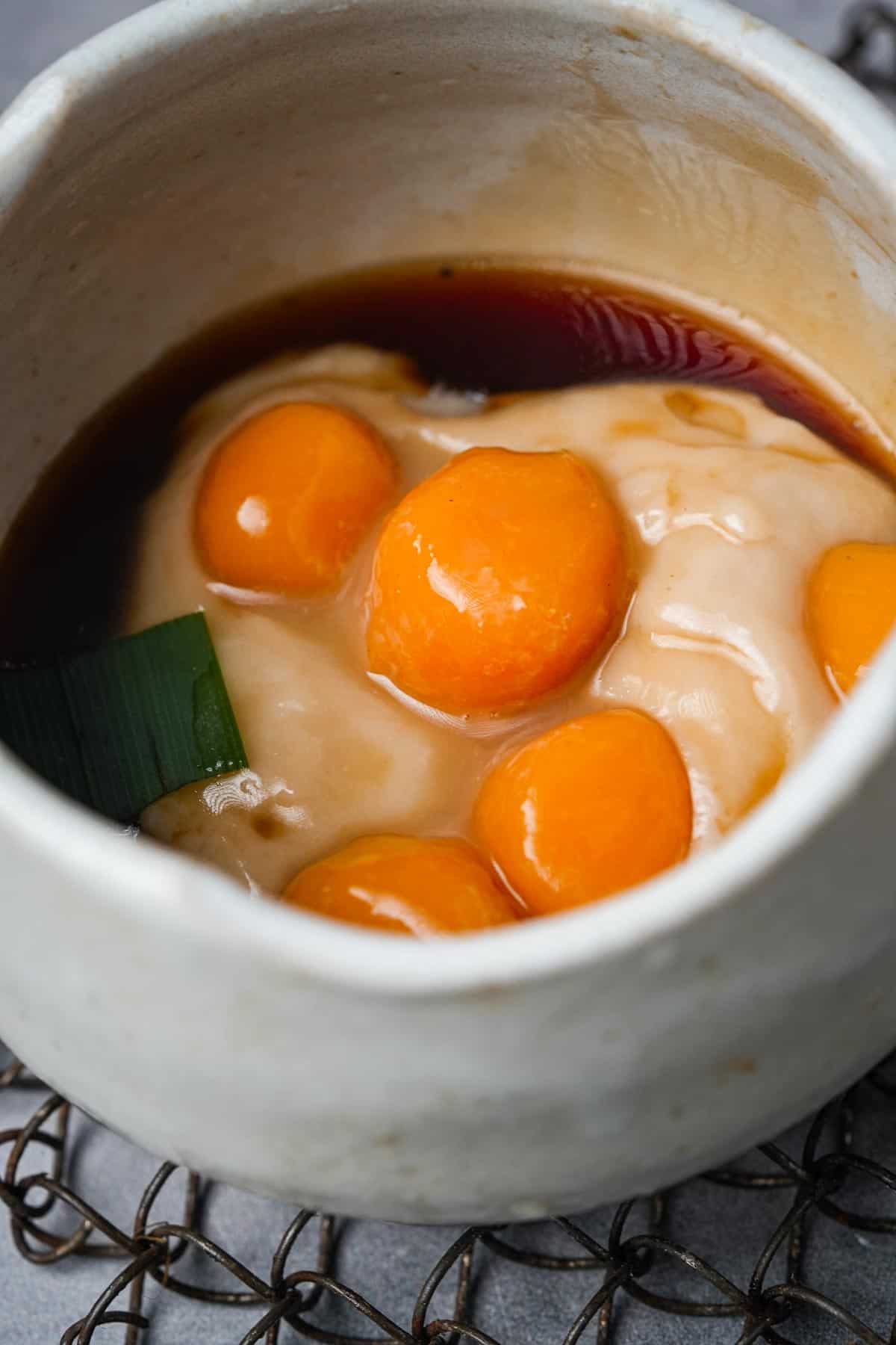 A bowl of buber sum sum with biji salak dumplings in it.