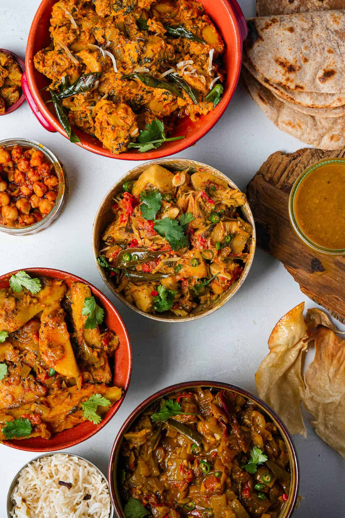Various bowls of indian food on a table.