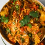 Kathal ki sabji in a red bowl on a table.