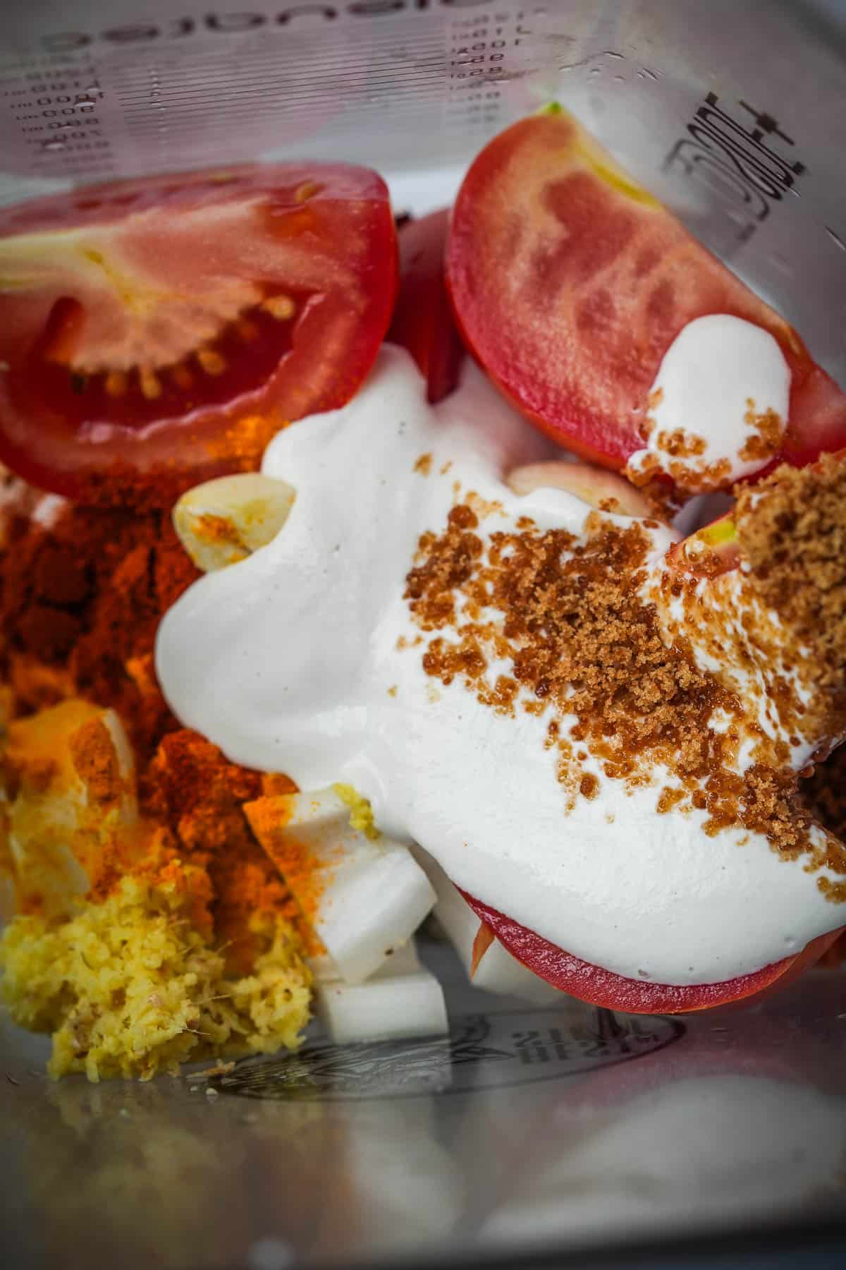 Curry base ingredients in a blender pitcher.