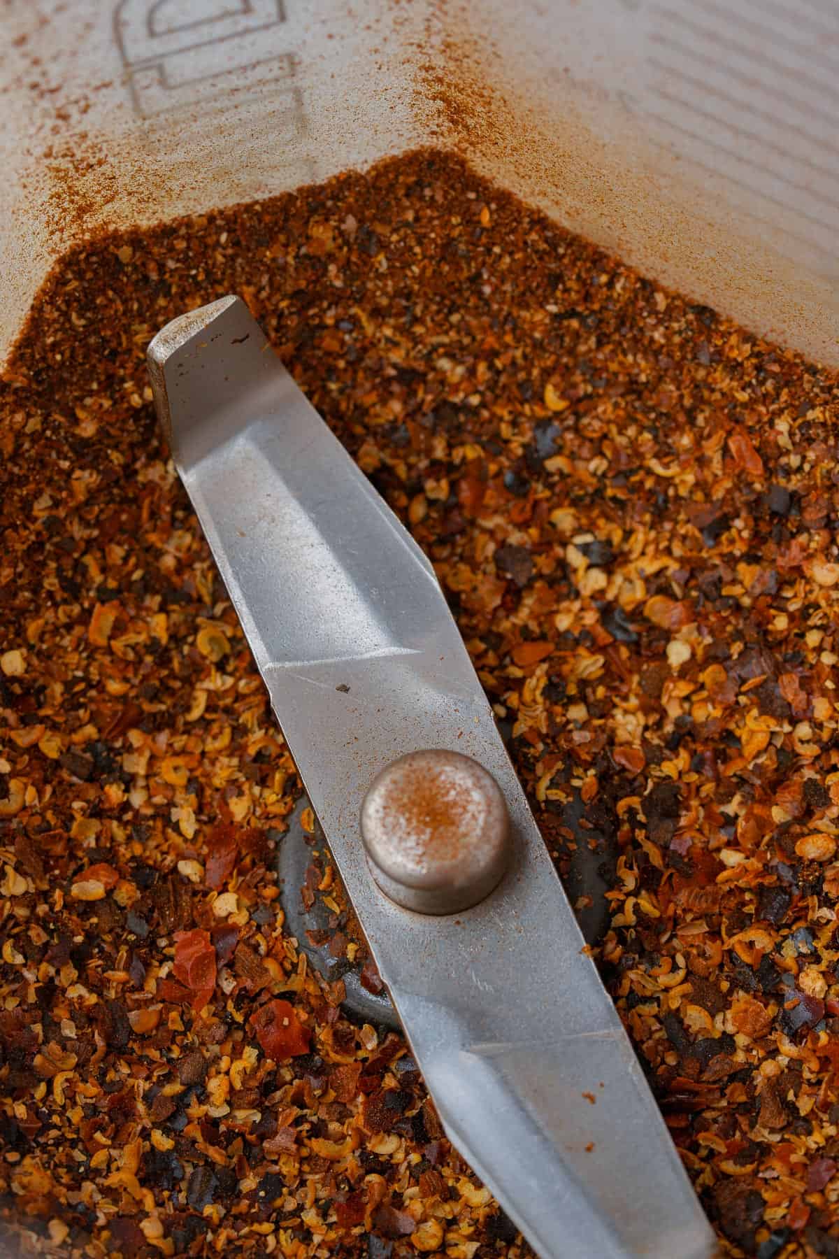 Toasted chilies are ground into a coarse powder in a blender.