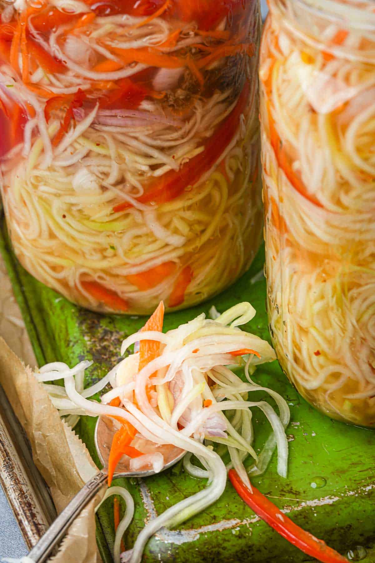 Two jars of acahara in a green tray.