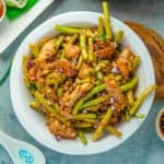 Vegan Adobong Sitaw with jackfruit and tofu in a white bowl.