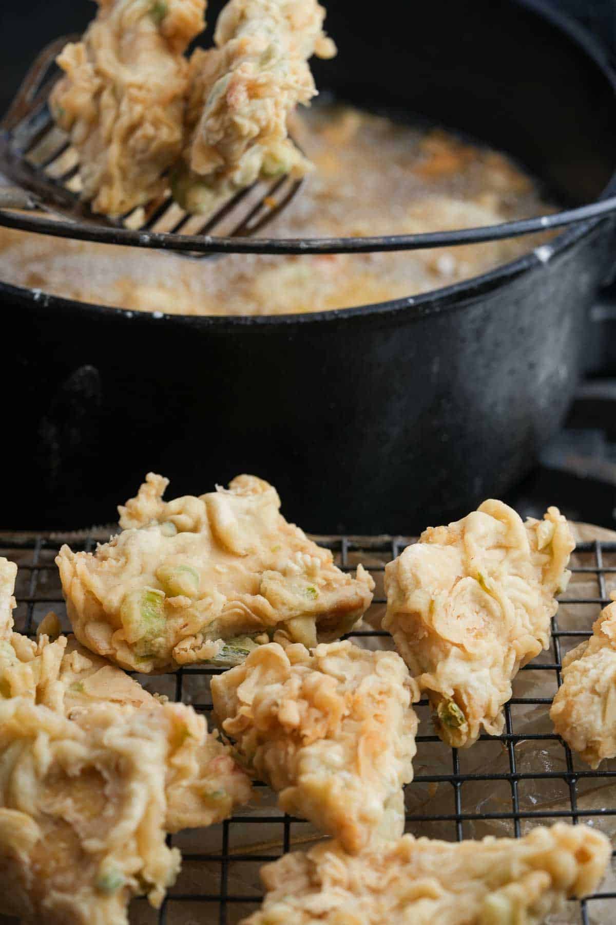 Fried tempe mendoan on a cooling rack.