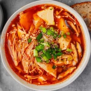 Korean tofu soup in a bowl on a gray background.