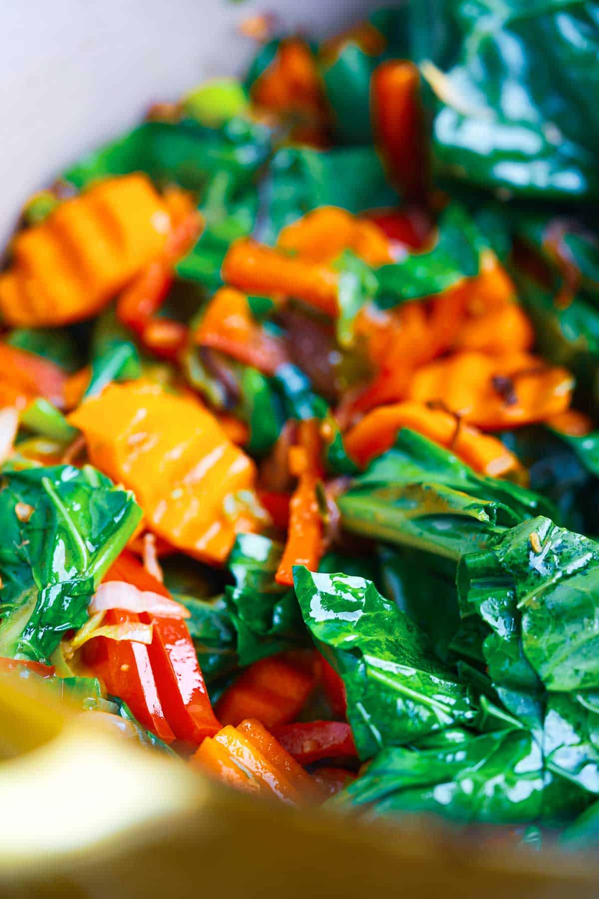 A yellow pot with vegetables in it.