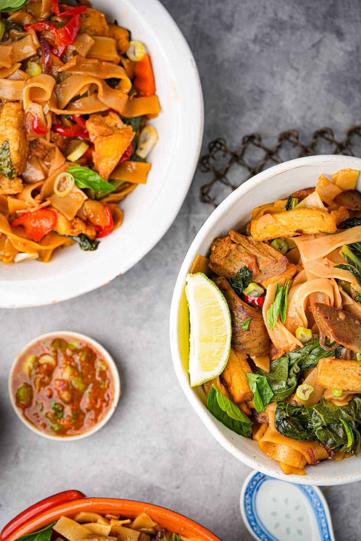 Thai noodle bowls with seitan, vegetables and fresh Thai basil.