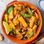 Thai fried noodles in an orange bowl.