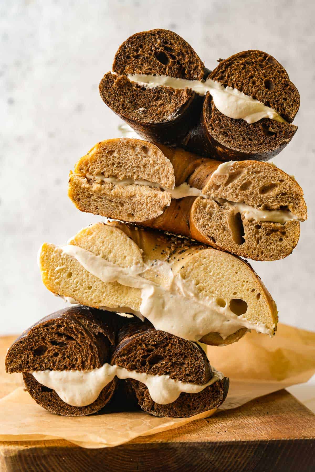 A stack of bagels with vegan cream cheese on them.
