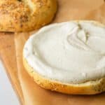 A bagel with cream cheese on top.