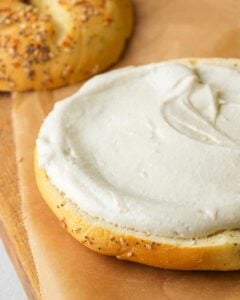 A bagel with cream cheese on top.