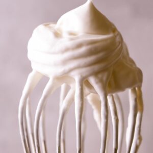 A close up of whipped cream on a whisk.