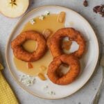 Picarones with chamomile apple syrup on a plate.