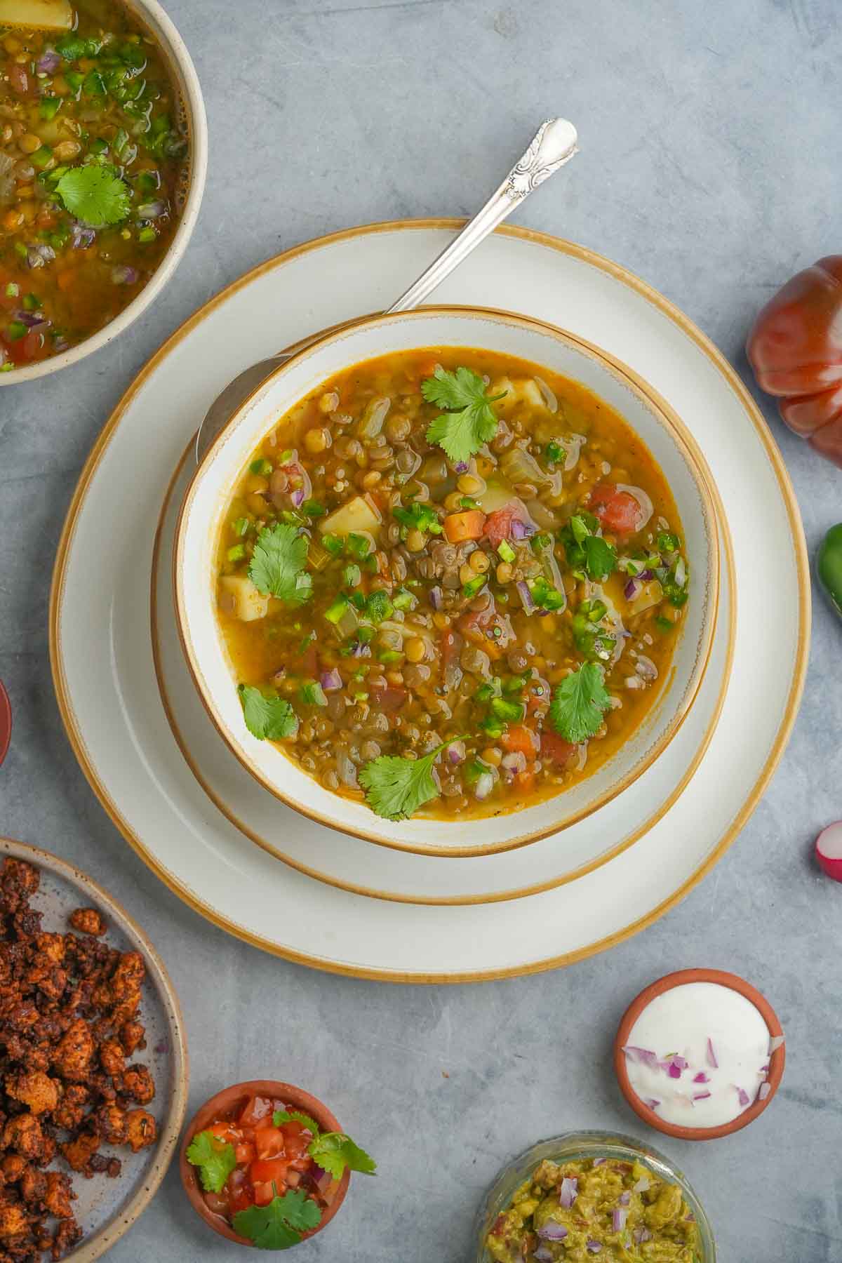 A bowl of Mexican lentil soup on a table.