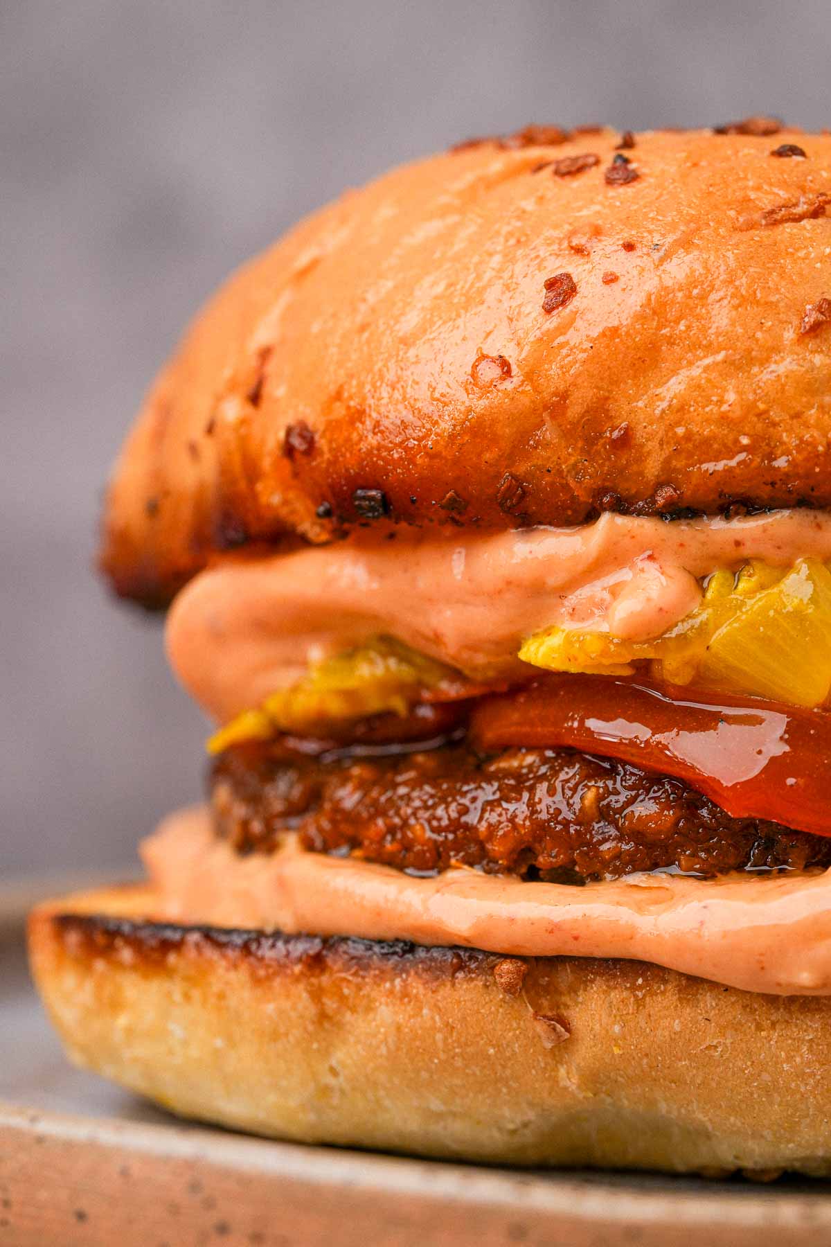 Close up of a Vegan Breakfast Sausage sandwich with scrambled tofu and chipotle mayo.