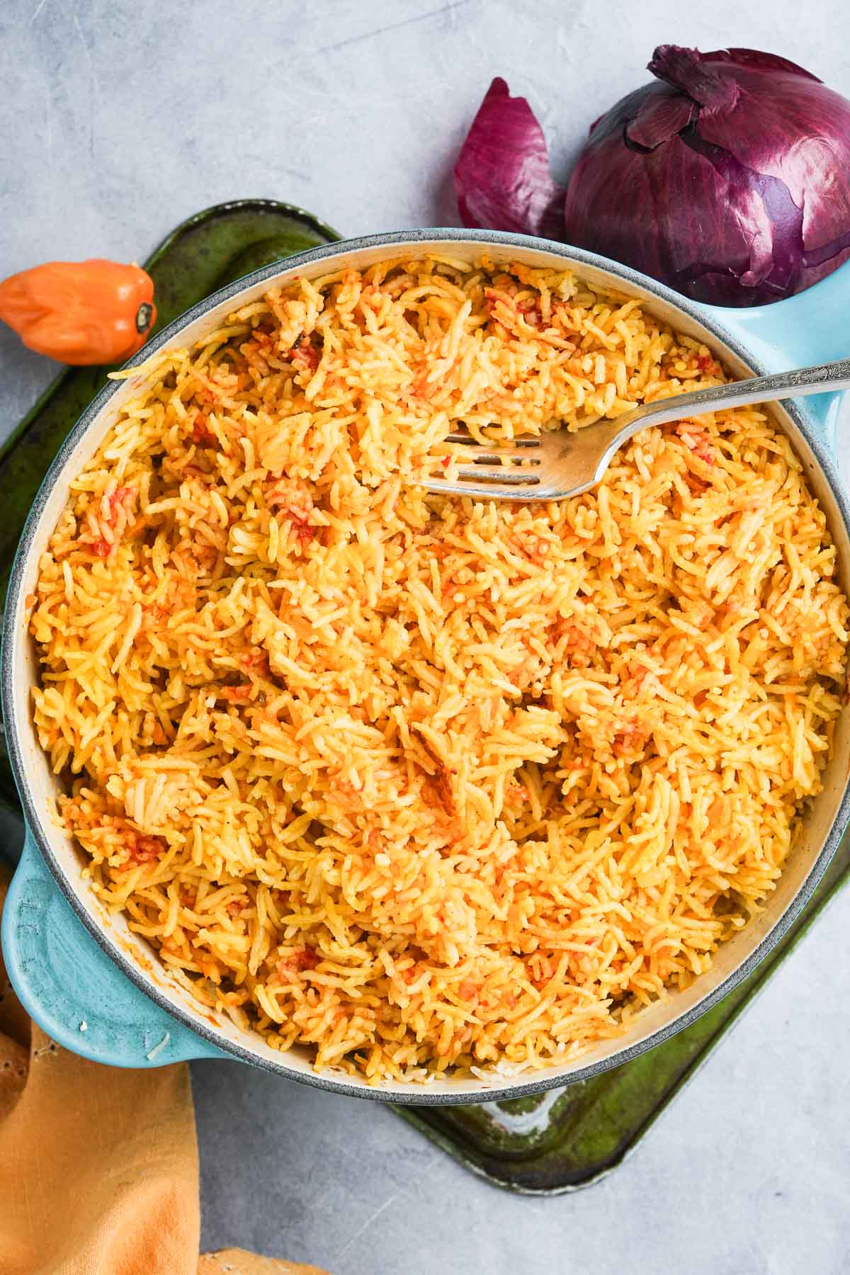A pot of Vegan Mexican Rice being fluffed with a fork.