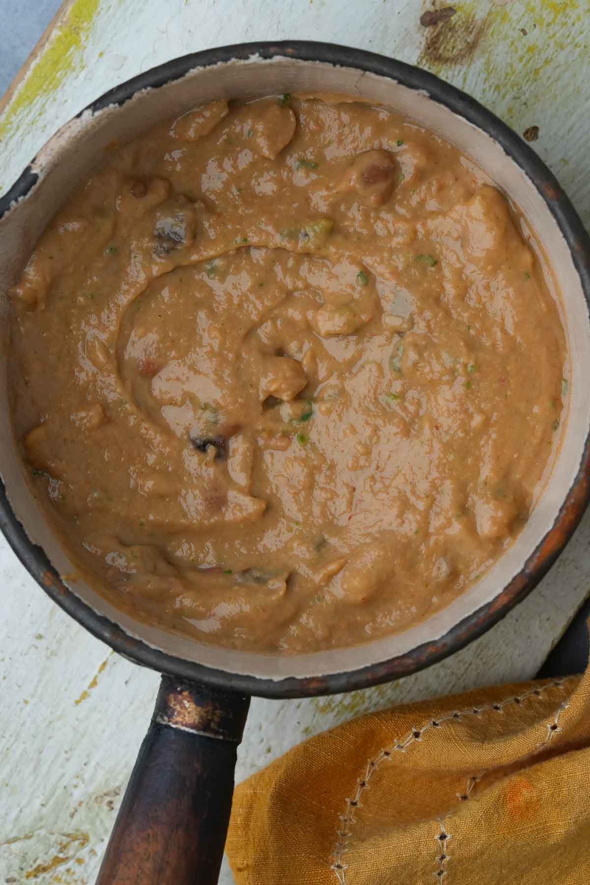 A pot of warmed vegan refried beans.