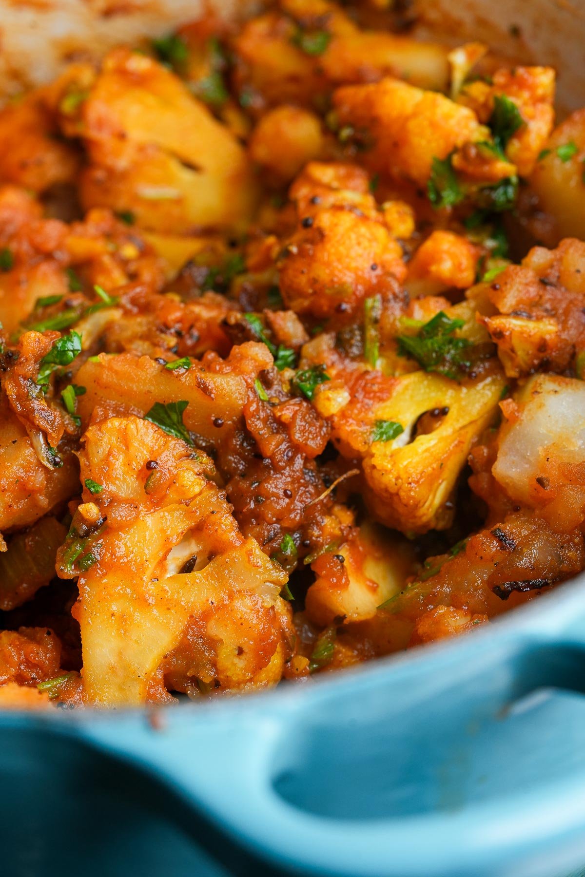 Close-up of a pot of Aloo Gobi cooking on the stovetop.
