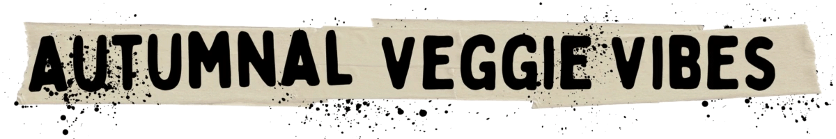 Text reading "AUTUMNAL VEGGIE VIBES" in bold, black letters on a beige, paint-like background with ink splatters, evoking vegan recipes.