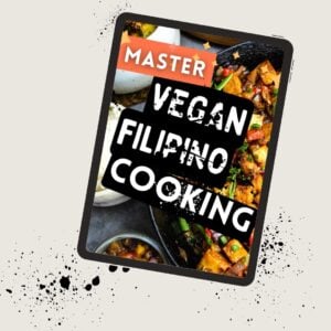 A digital tablet displays a cover titled "Master Vegan Filipino Cooking" with images of vegan Filipino dishes in the background.