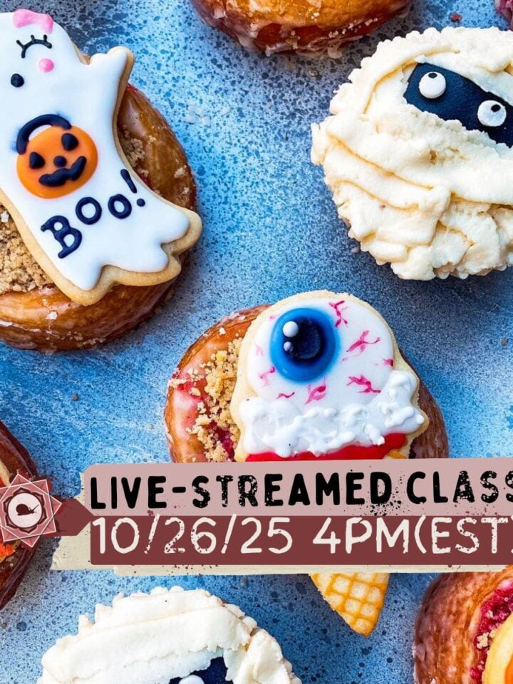 Assorted Halloween-themed donuts and cookies are arranged on a blue surface, with text announcing a live-streamed class on 10/26/25 at 4PM (EST).