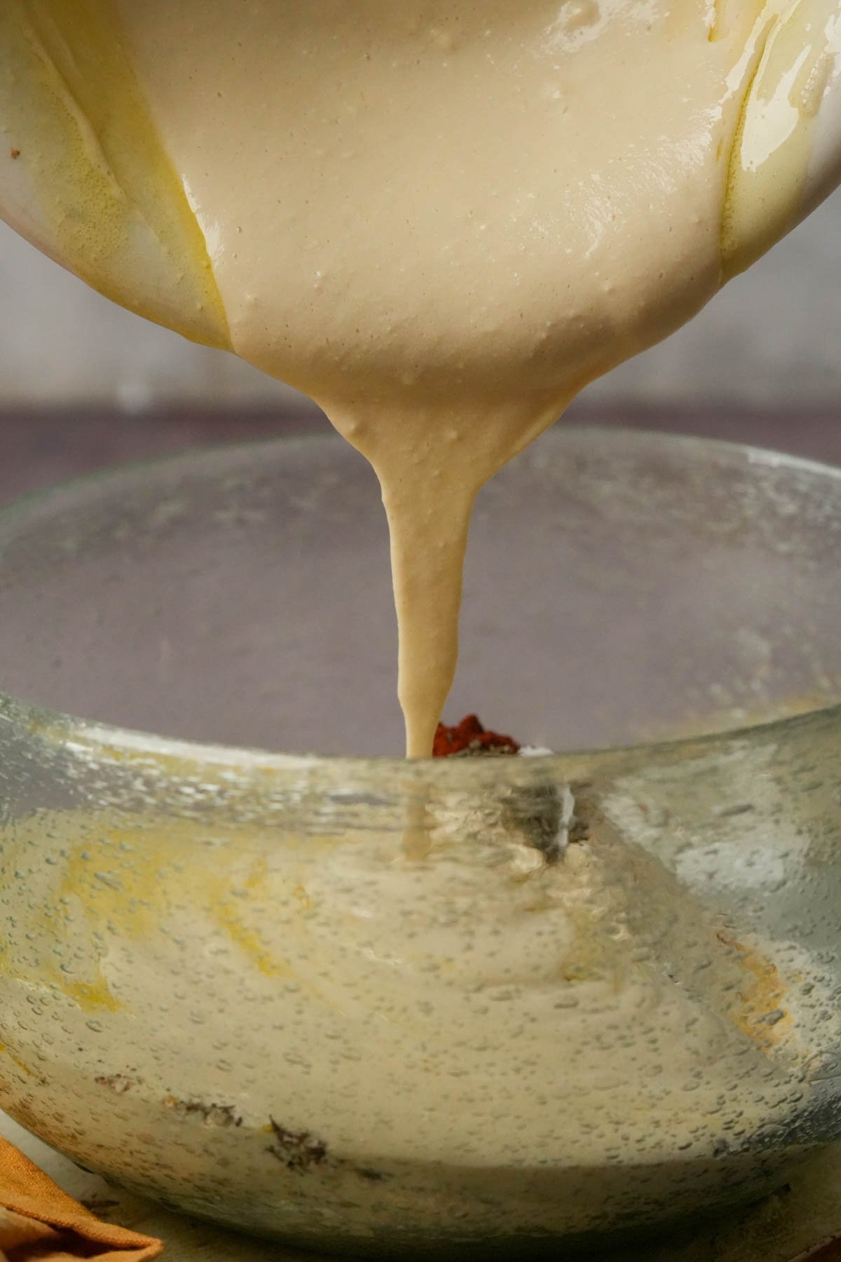 Liquid ingredients being added to dry for a vegan corn casserole batter.