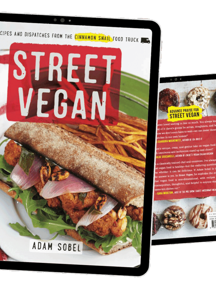 The image shows the front and back covers of the book Street Vegan by Adam Sobel, featuring a vegan sandwich with fries on the front and donuts on the back, displayed on two digital tablets.