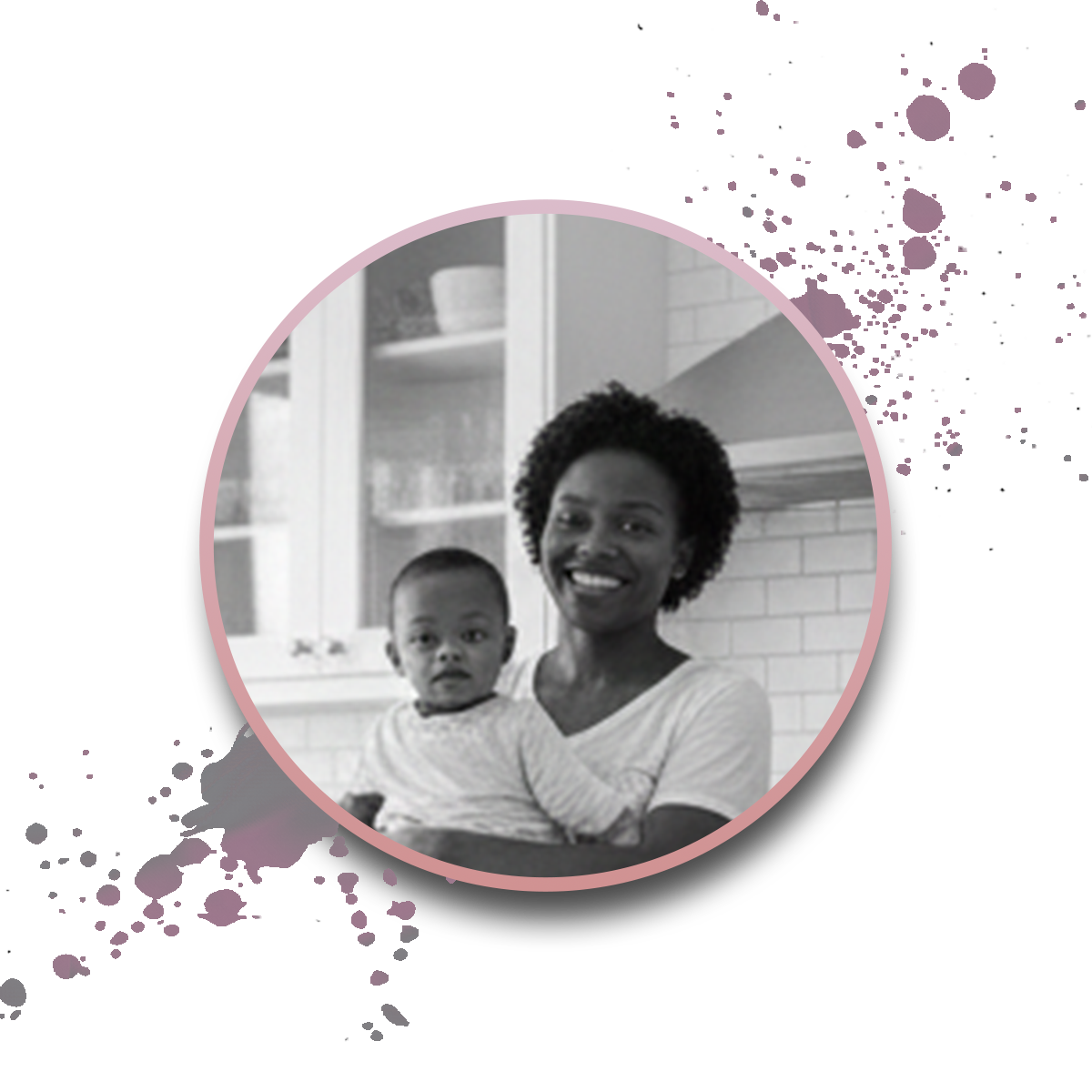 Black and white photo of a smiling woman holding a young child in a kitchen, set within a pink-bordered circle on a white background with purple paint splatters.