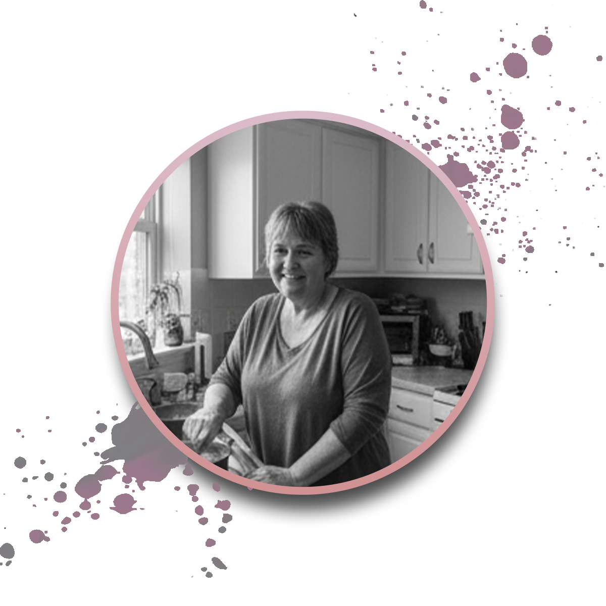 A woman smiles while standing in a kitchen, preparing food. The black-and-white photo is framed by a pink circle with purple paint splatters on a white background.