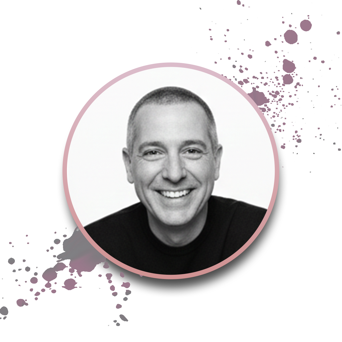Black-and-white portrait of a smiling man with short hair, wearing a dark top. The photo is in a circular frame with a pink border, over a white background with purple paint splatter accents.