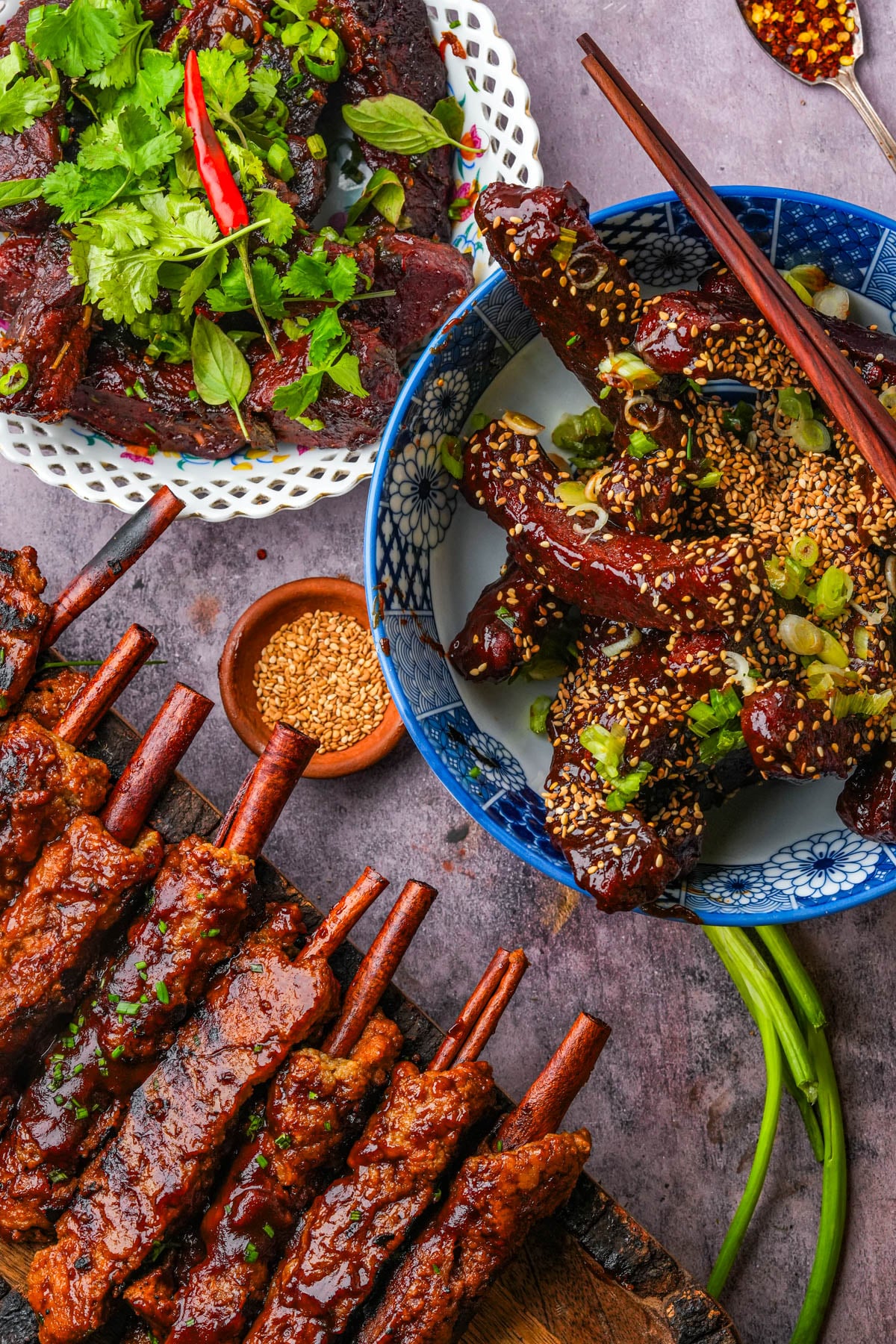 Vegan Chinese ribs next to vegan Thai seitan ribs and vegan BBQ ribs with cinnamon stick bones.