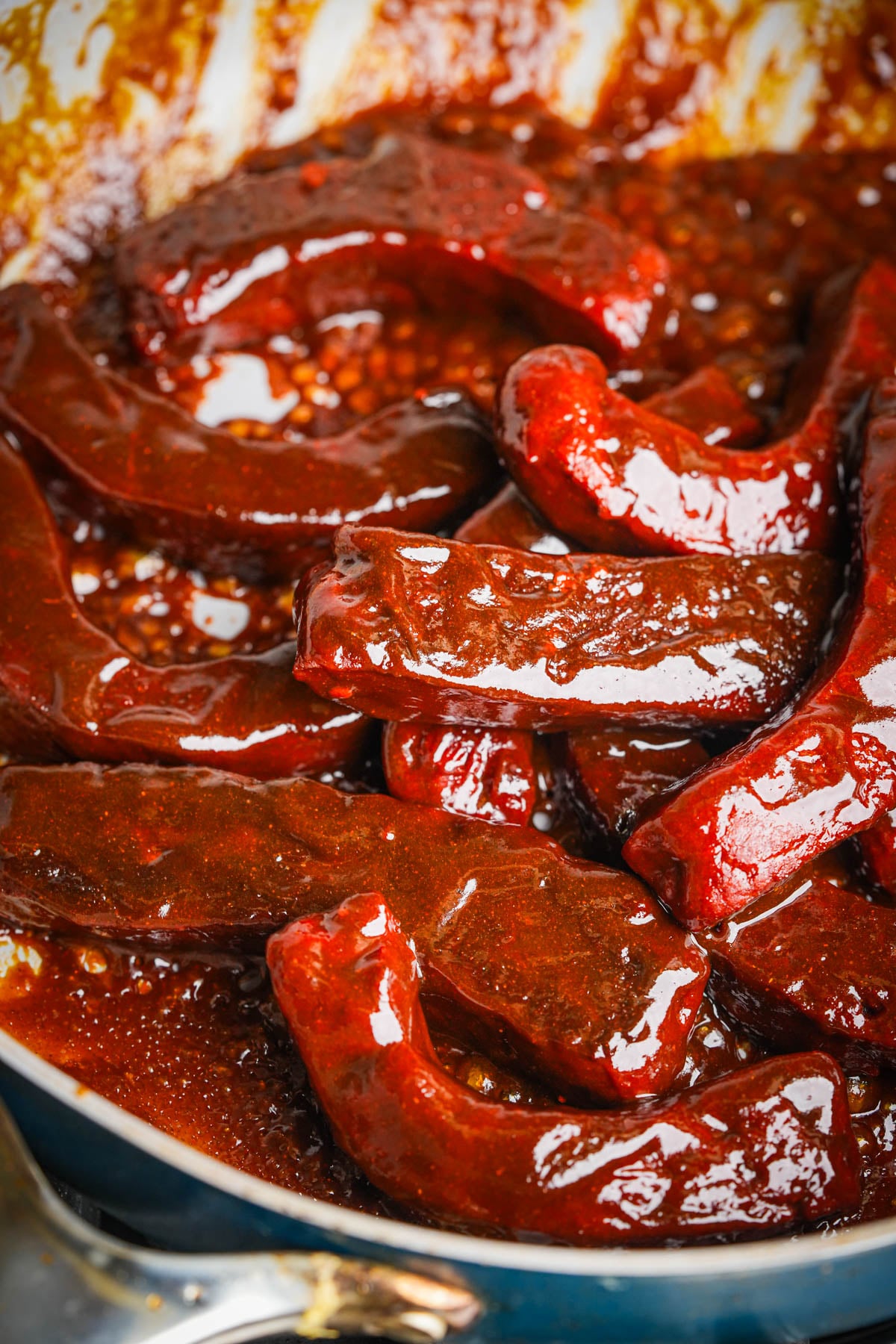 Vegan Chinese ribs tossed in the skillet until the red hoisin glaze thickens and clings.