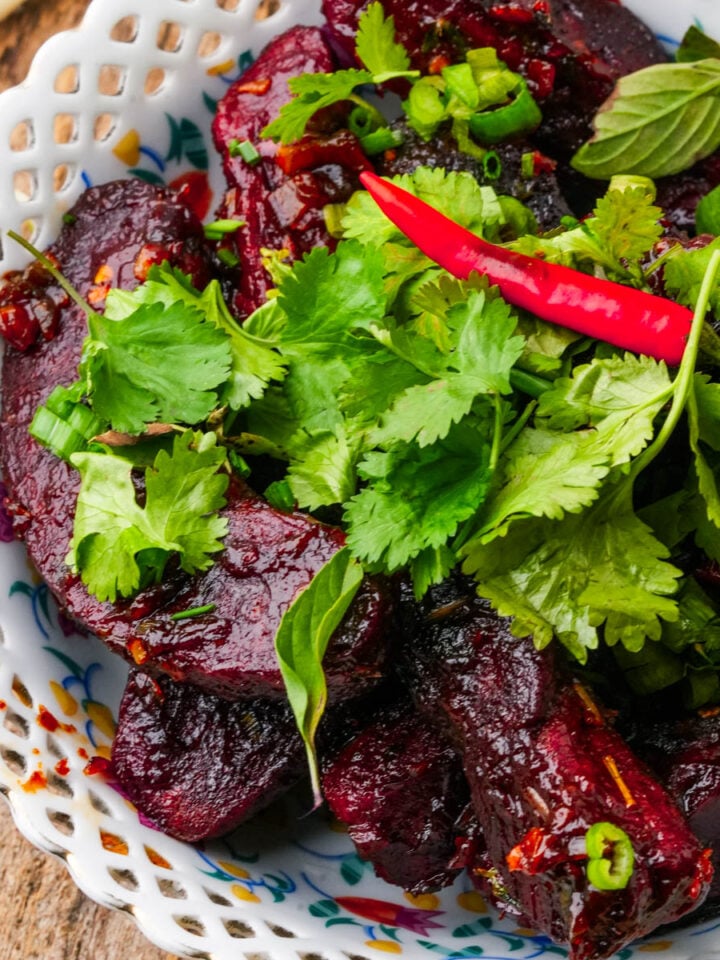 Vegan Thai seitan ribs in a lime chili sauce, topped with fresh cilantro and a bird's eye chili.