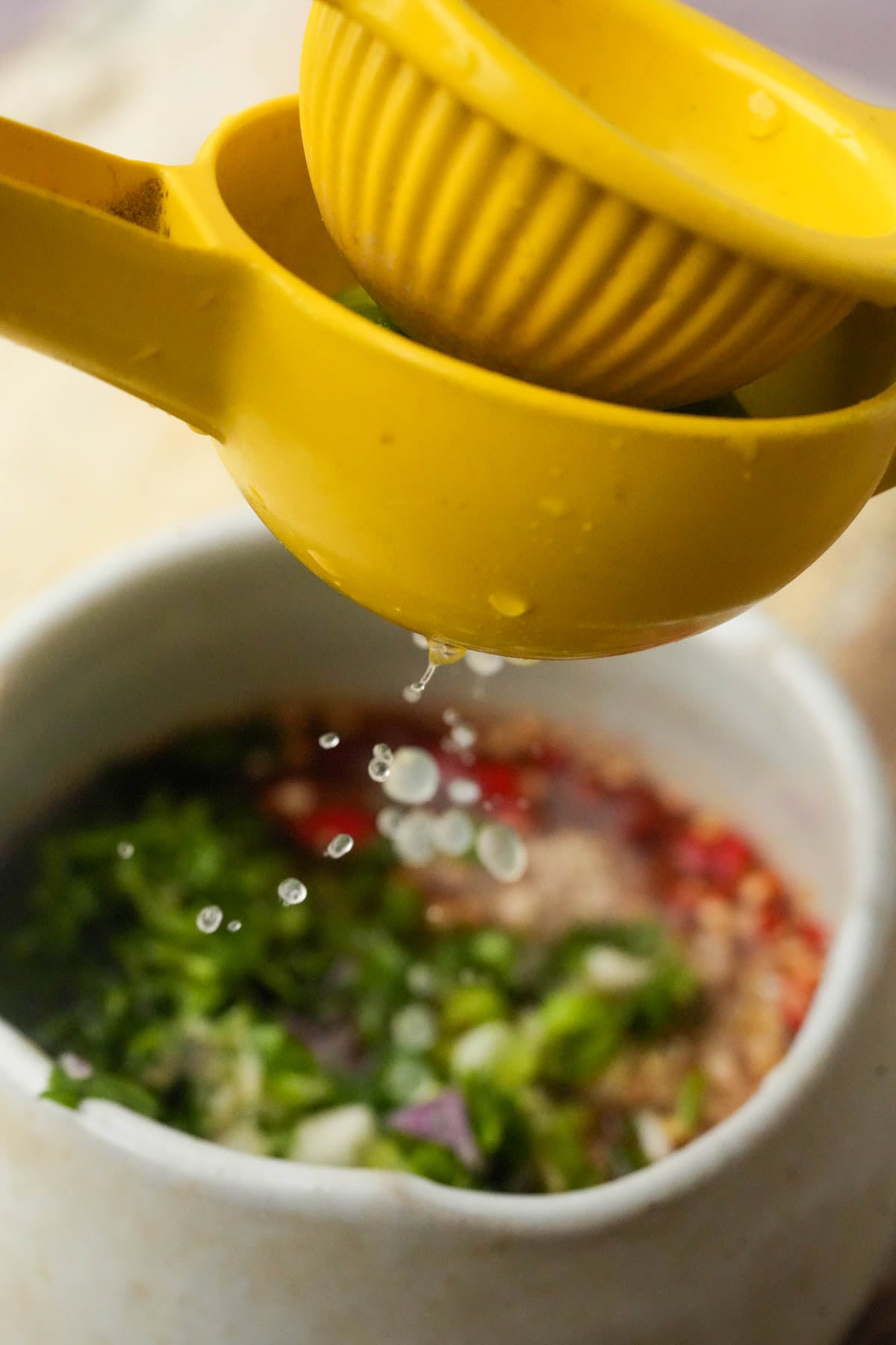 Lime juice squeezed into the vegan fish sauce, chili and herb sauce for the ribs.